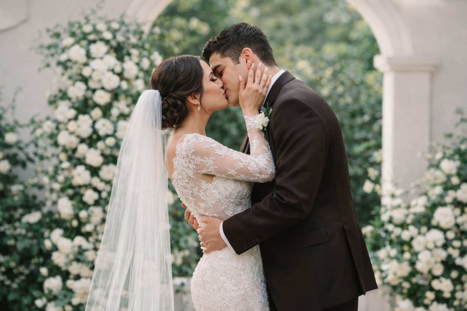 A couple sharing their first kiss at their Florida wedding